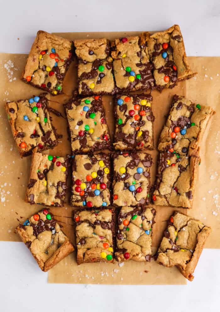 Craving cookies but short on time? These M&M Cookie Bars are like baking a batch of thick, chewy cookies in one pan with 10 minutes of prep. M&M Cookie Bars cut into squares