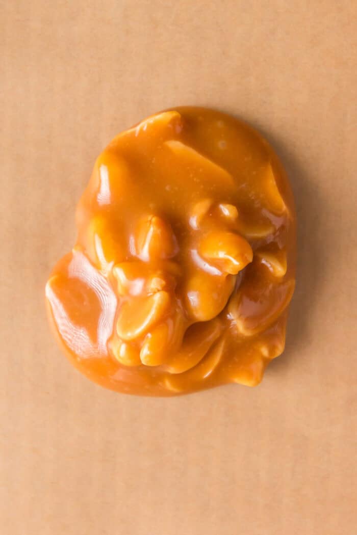 This Polar Bear Paws Candy recipe is a copycat version of See’s Candies that you can easily at home! peanut candy mixture on parchment paper