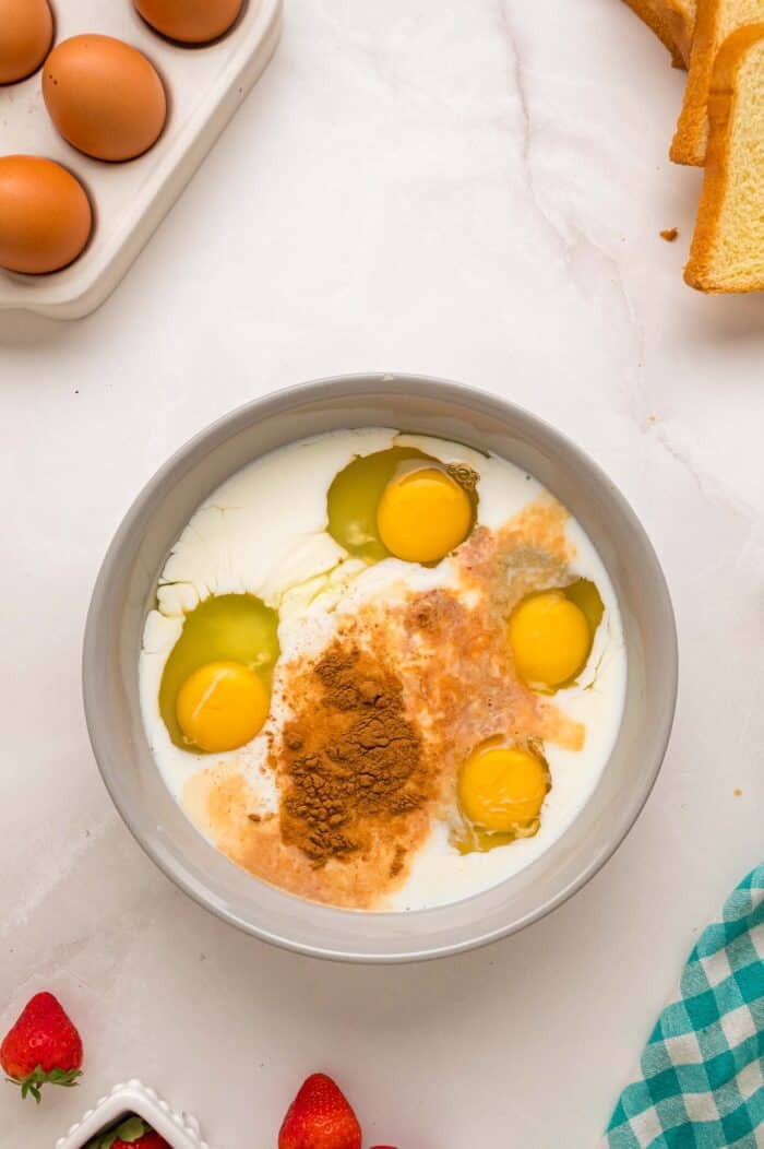 This Cream Cheese Stuffed French Toast recipe is an easy, decadent way to elevate basic French toast. Perfect for weekend brunch! Eggs, milk, cinnamon, and vanilla in a bowl