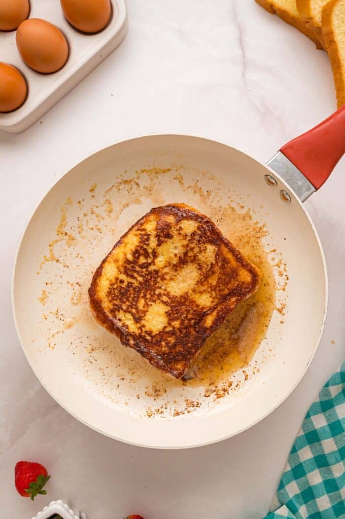This Cream Cheese Stuffed French Toast recipe is an easy, decadent way to elevate basic French toast. Perfect for weekend brunch! Stuffed French toast in a skillet