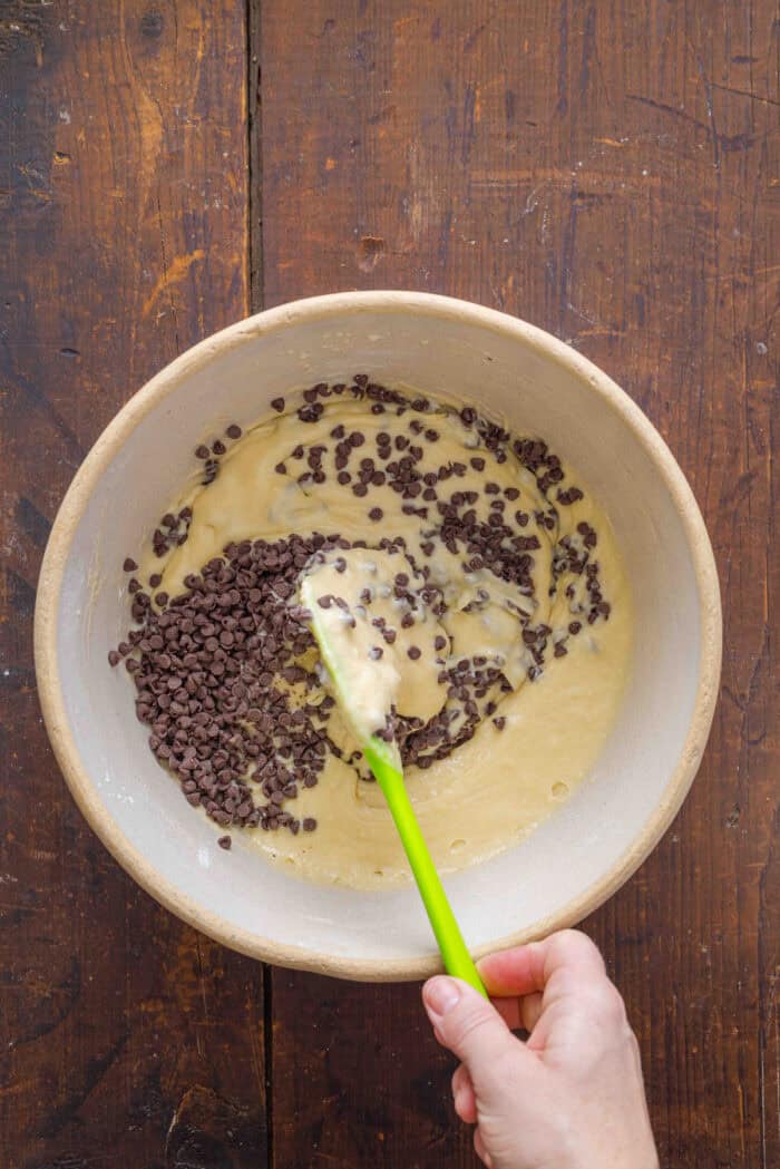 Folding mini chocolate chips into muffin batter
