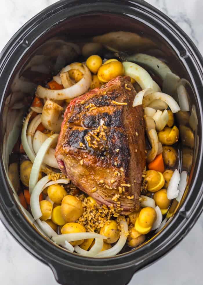 This Slow Cooker Coca Cola Pot Roast is the ultimate hearty, comforting dinner that practically makes itself. Seared chuck roast, onions, carrots, and potatoes in a slow cooker