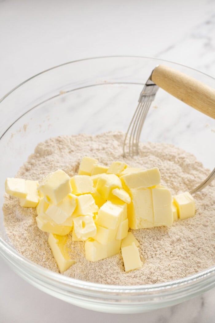 Tender, moist cake is topped with a thick layer of cinnamon crumb topping in this Easy Crumb Cake Recipe. Enjoy with a cup of coffee. Cutting butter into dry ingredients