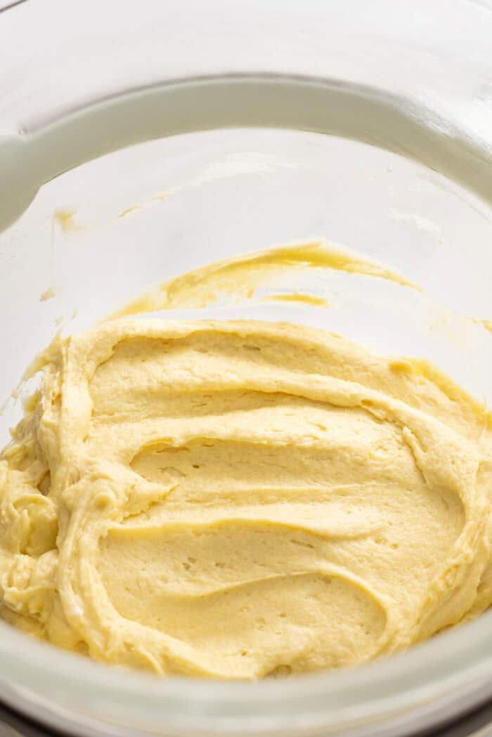 Tender, moist cake is topped with a thick layer of cinnamon crumb topping in this Easy Crumb Cake Recipe. Enjoy with a cup of coffee. Crumb cake batter in a bowl