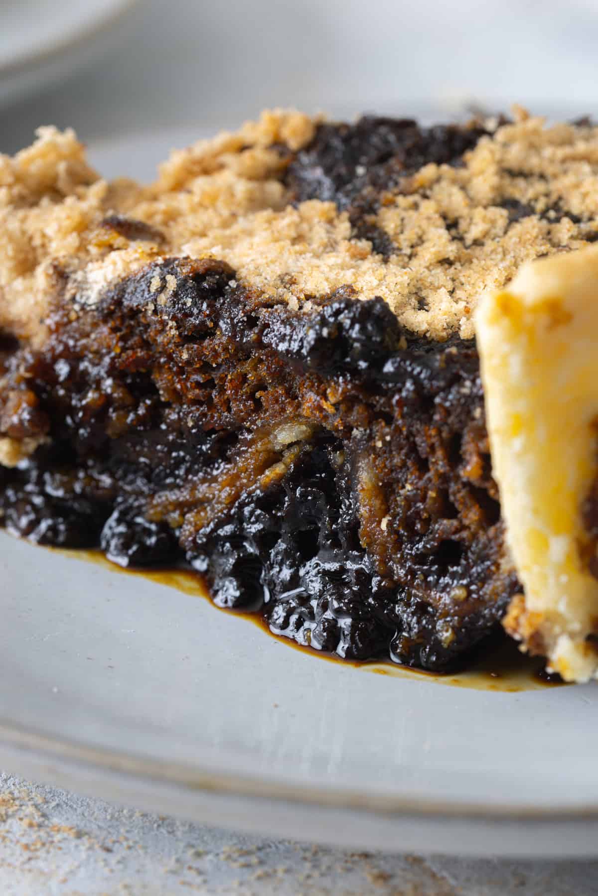 A slice of shoo fly pie on a white plate