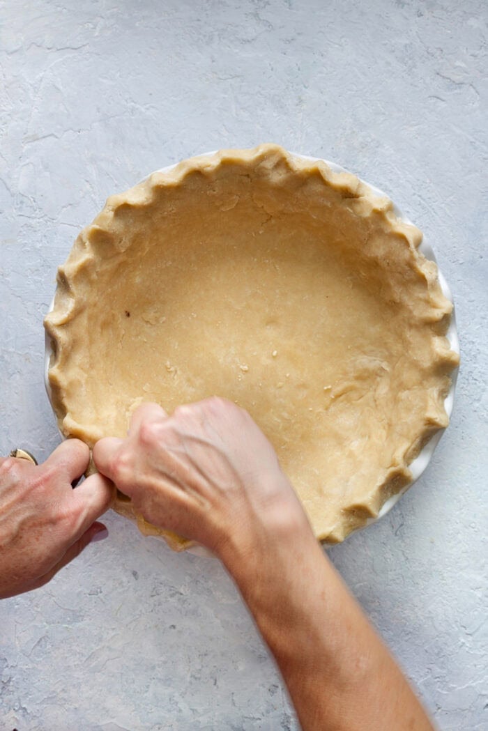 Crimping the edges of pie crust in a pie pan