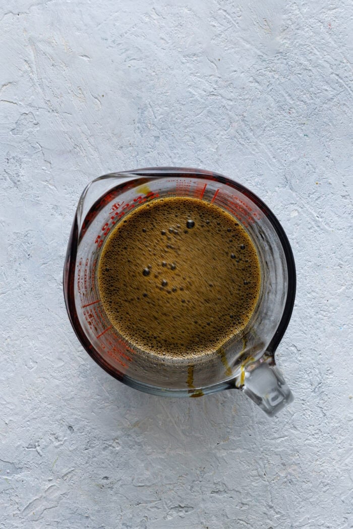 Molasses mixed with hot water in a measuring cup