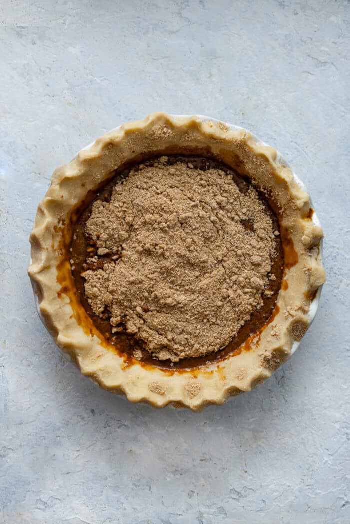 Crumb topping on molasses filling in a pie crust