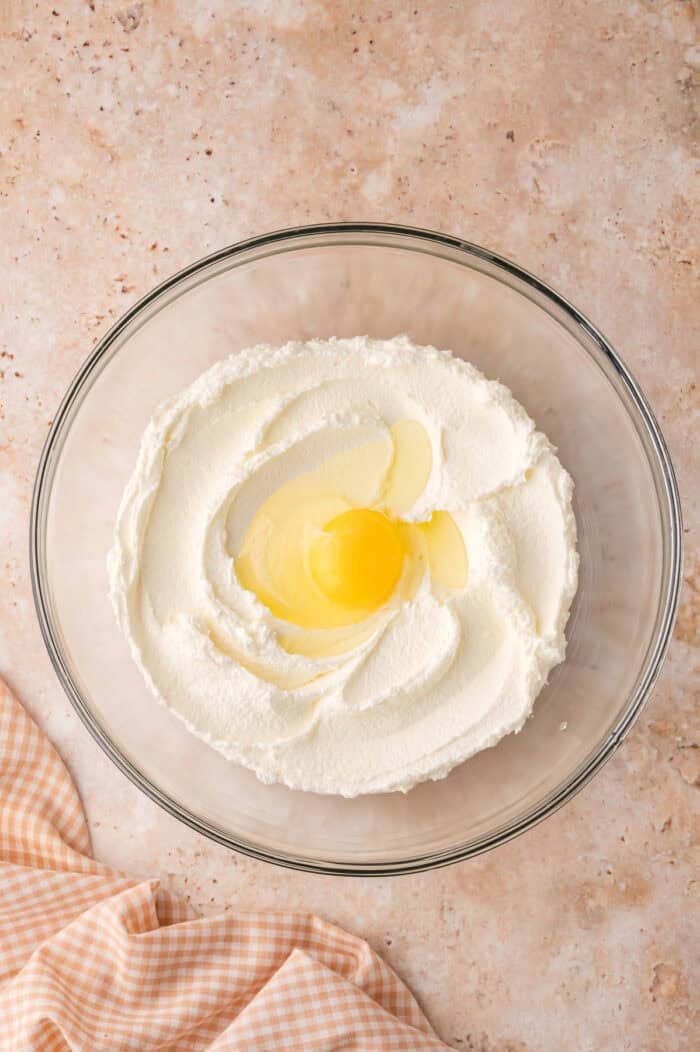 This Sour Cream Coffee Cake is soft and buttery with a generous cinnamon sugar ribbon baked through the middle & streusel topping. Egg added to creamed butter and sugar