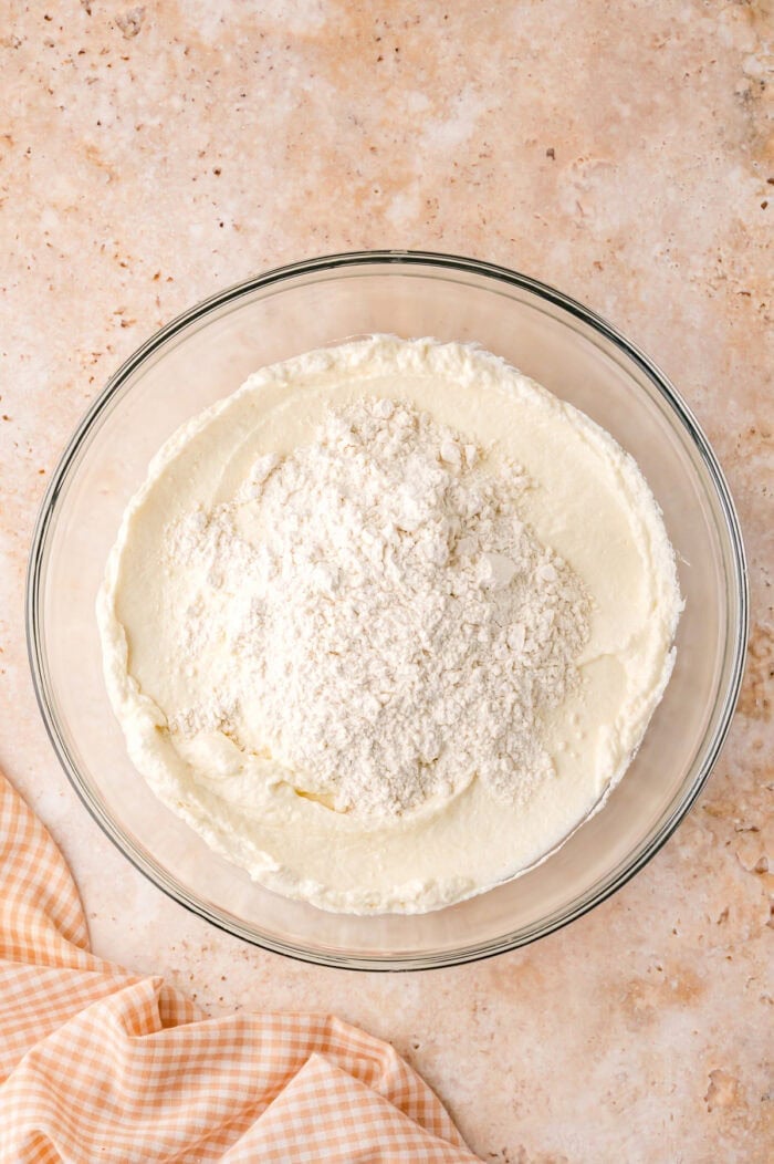 This Sour Cream Coffee Cake is soft and buttery with a generous cinnamon sugar ribbon baked through the middle & streusel topping. Combining wet and dry coffee cake ingredients