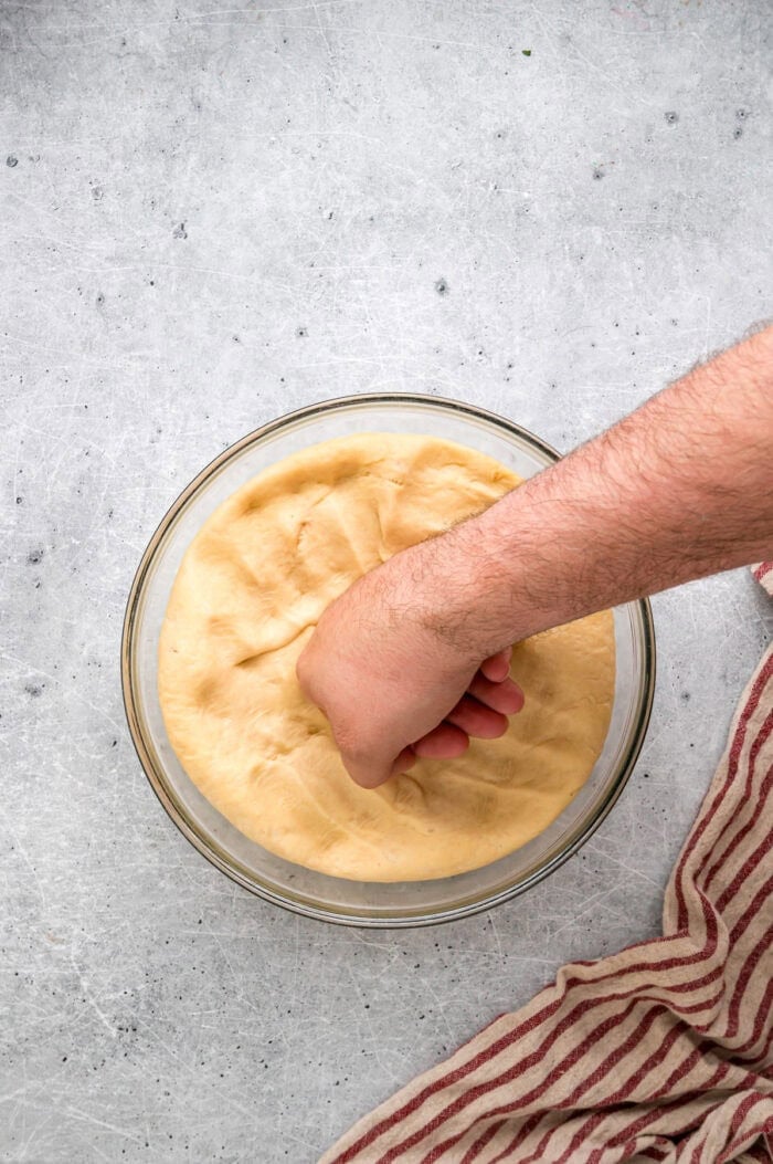 This Hawaiian Rolls recipe makes soft, fluffy rolls that taste just like the store-bought version – maybe even better. Punching down dough in a glass bowl