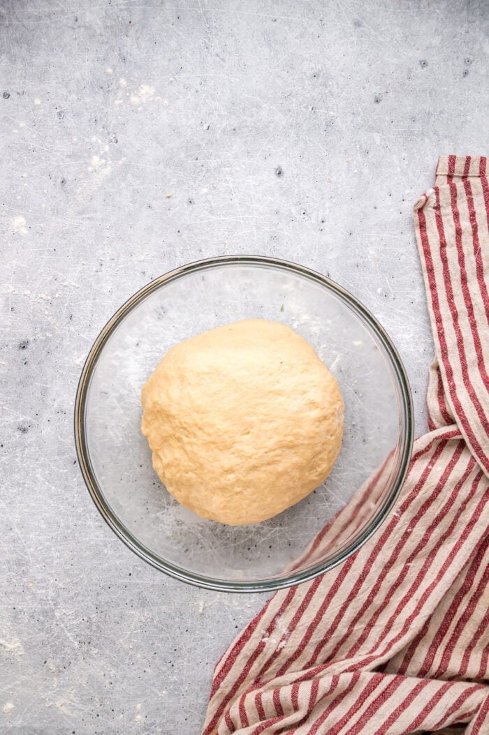 This Hawaiian Rolls recipe makes soft, fluffy rolls that taste just like the store-bought version – maybe even better. Bread dough in a glass bowl