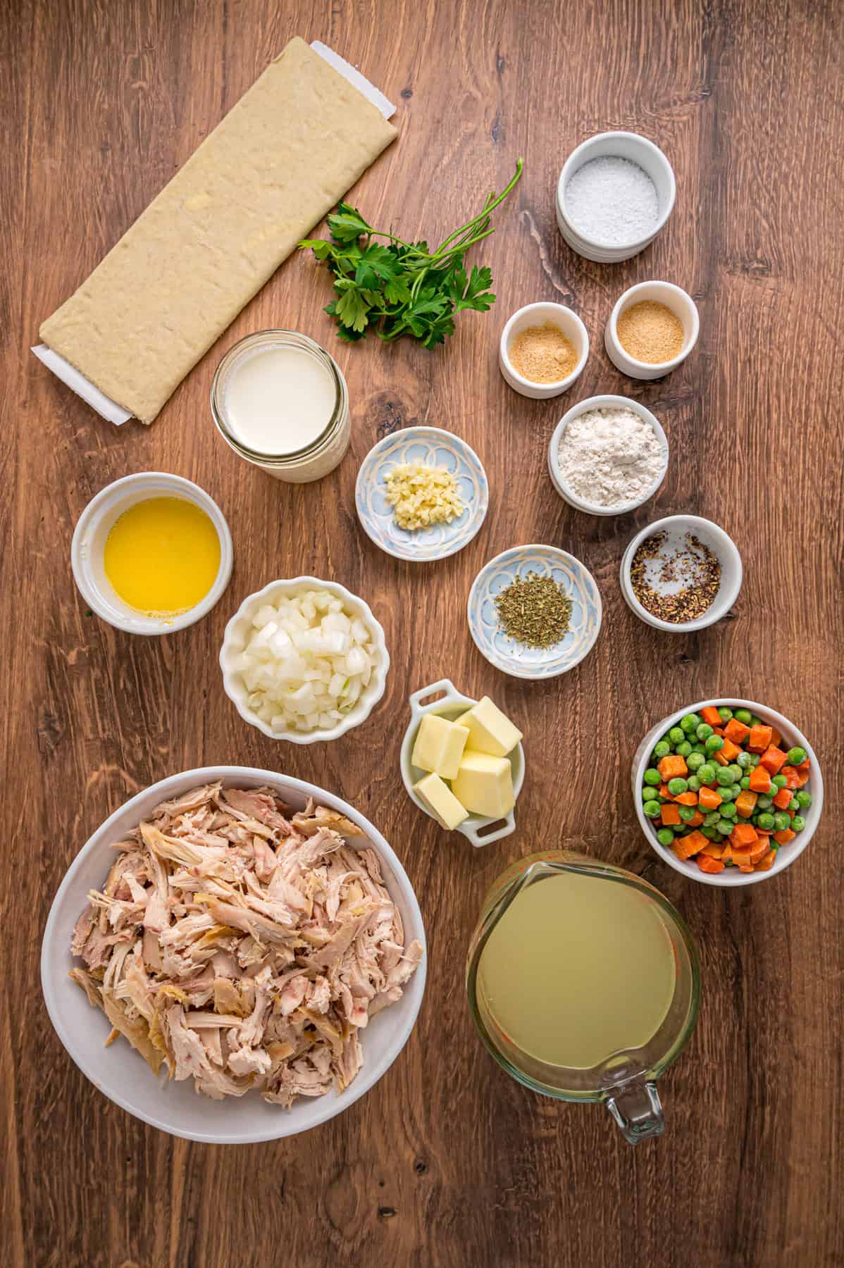 A creamy mixture of veggies and chicken is topped with a flaky, buttery topping in this Puff Pastry Chicken Pot Pie Recipe. Overhead view of ingredients needed to make Puff Pastry Chicken Pot Pie