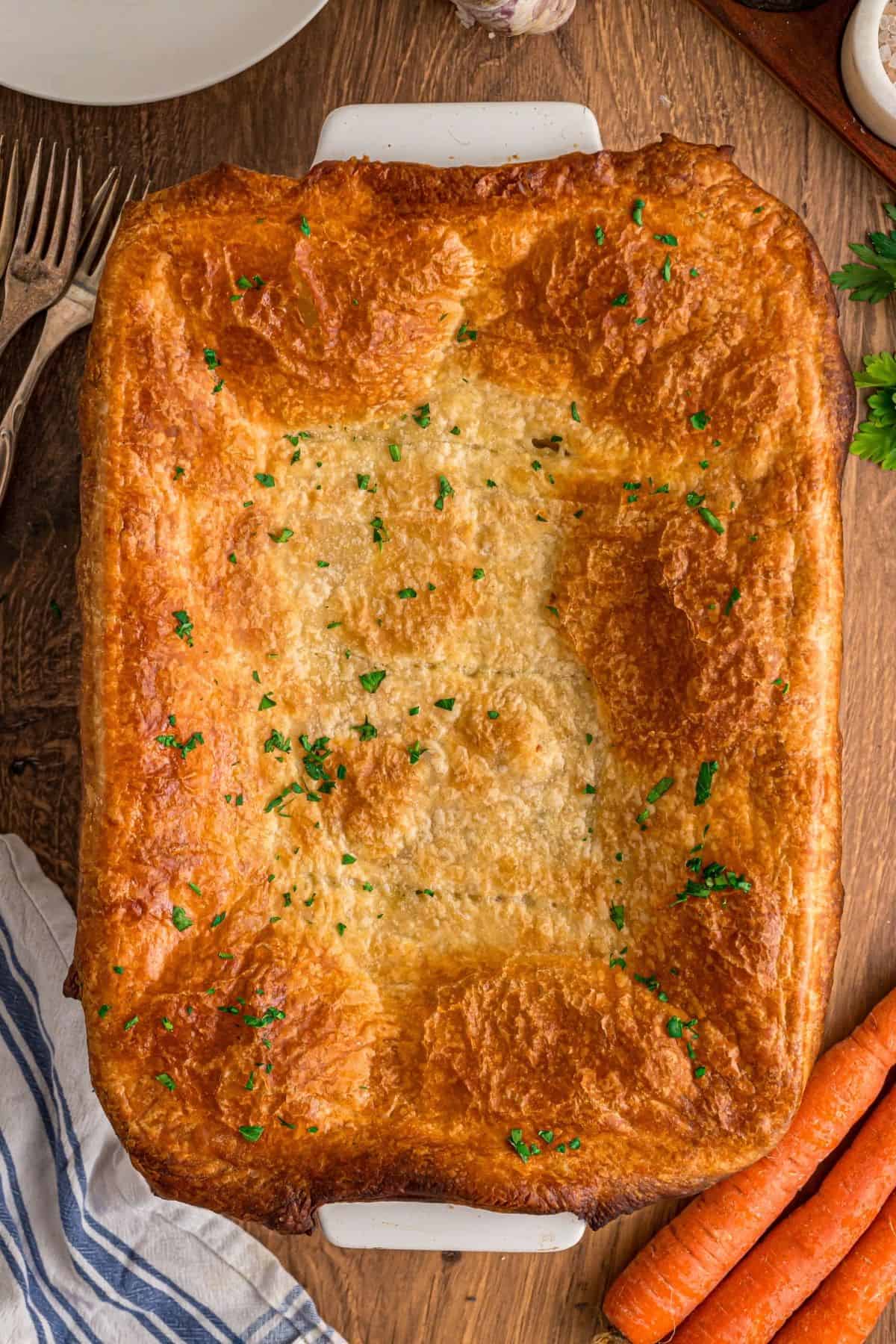 A creamy mixture of veggies and chicken is topped with a flaky, buttery topping in this Puff Pastry Chicken Pot Pie Recipe. Puff Pastry Chicken Pot Pie baked