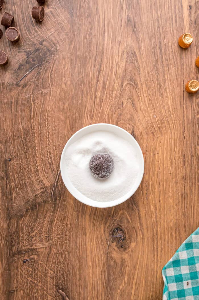 A ball of cookie dough rolled in sugar