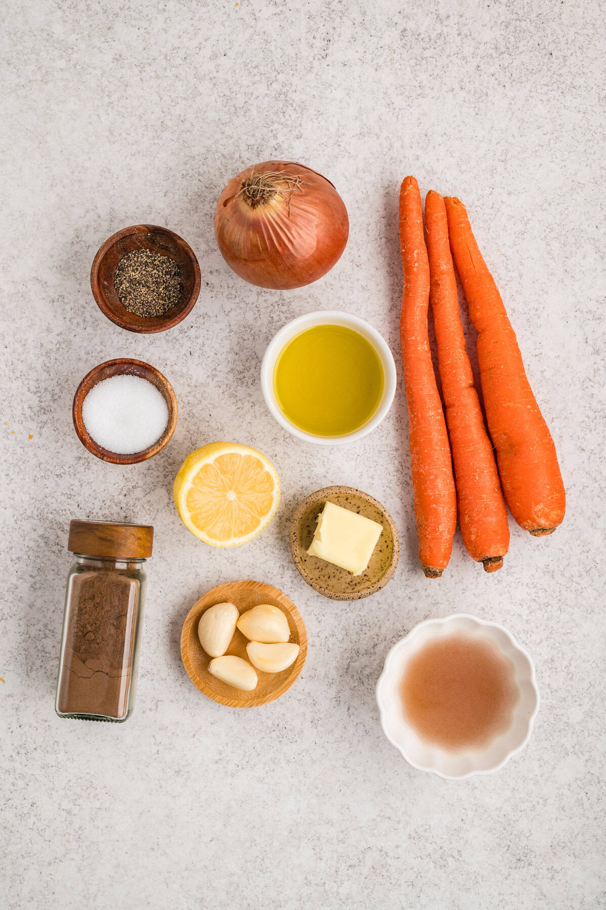 With caramelized carrots, onion, and garlic, this Roasted Carrot Soup is ready in 45 minutes. Gluten-free & vegetarian! Overhead view of ingredients needed to make carrot soup