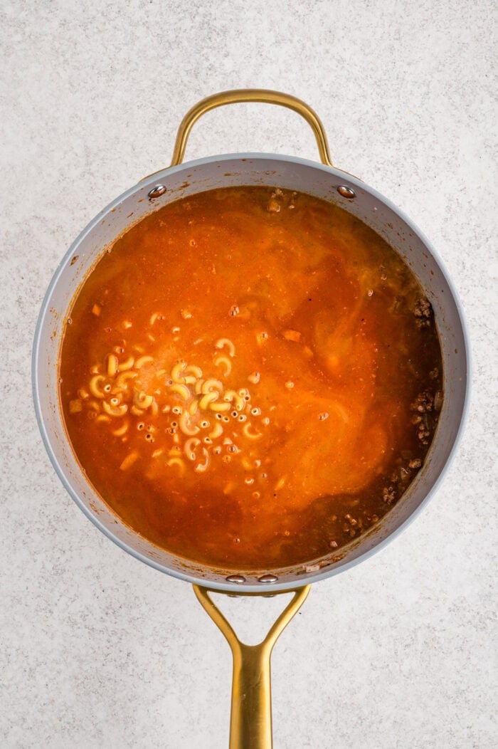 Macaroni noodles and broth added to the ground beef mixture.