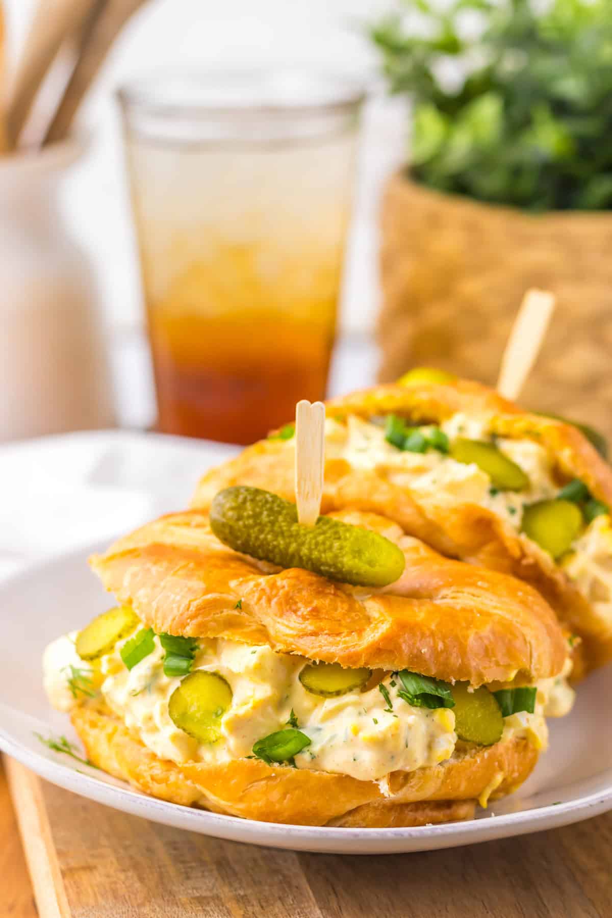 Two dill pickle egg salad sandwiches on a plate