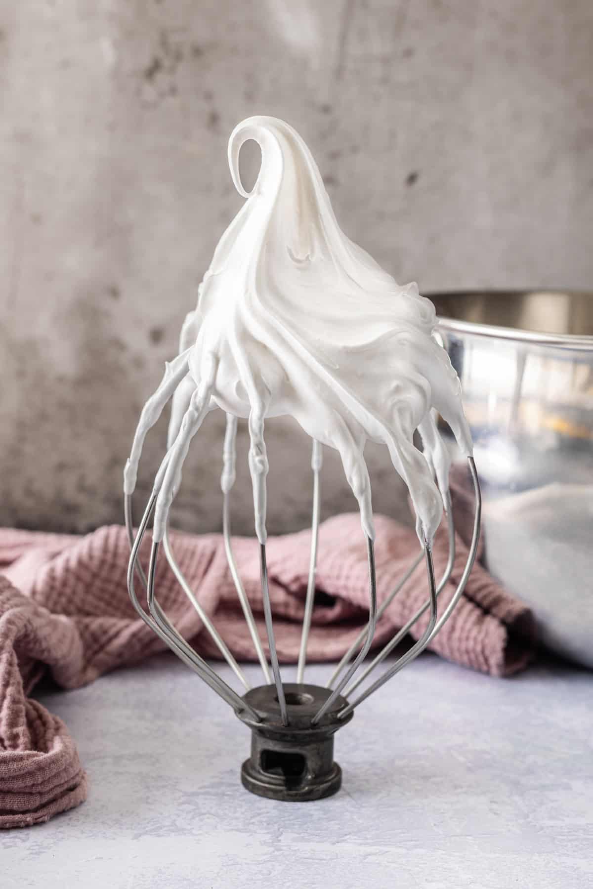 Light and fluffy just like a marshmallow, this Marshmallow Frosting recipe takes just 5 ingredients and 10 minutes to prepare. Marshmallow frosting on a spatula with stiff peaks