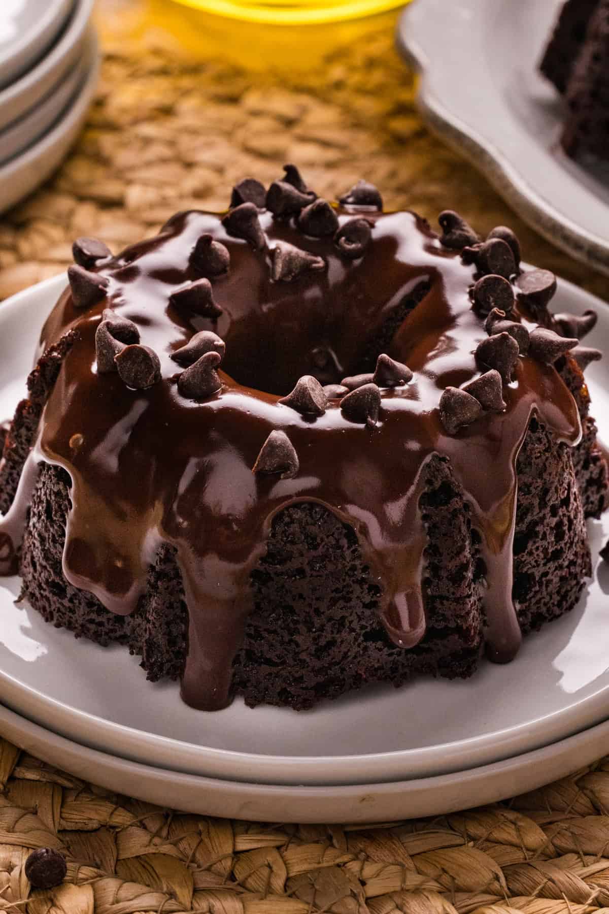 These Mini Chocolate Bundt Cakes offer a rich chocolate flavor and ultra-moist crumb in perfectly portioned, individual cakes. A mini chocolate bundt cake on a white plate