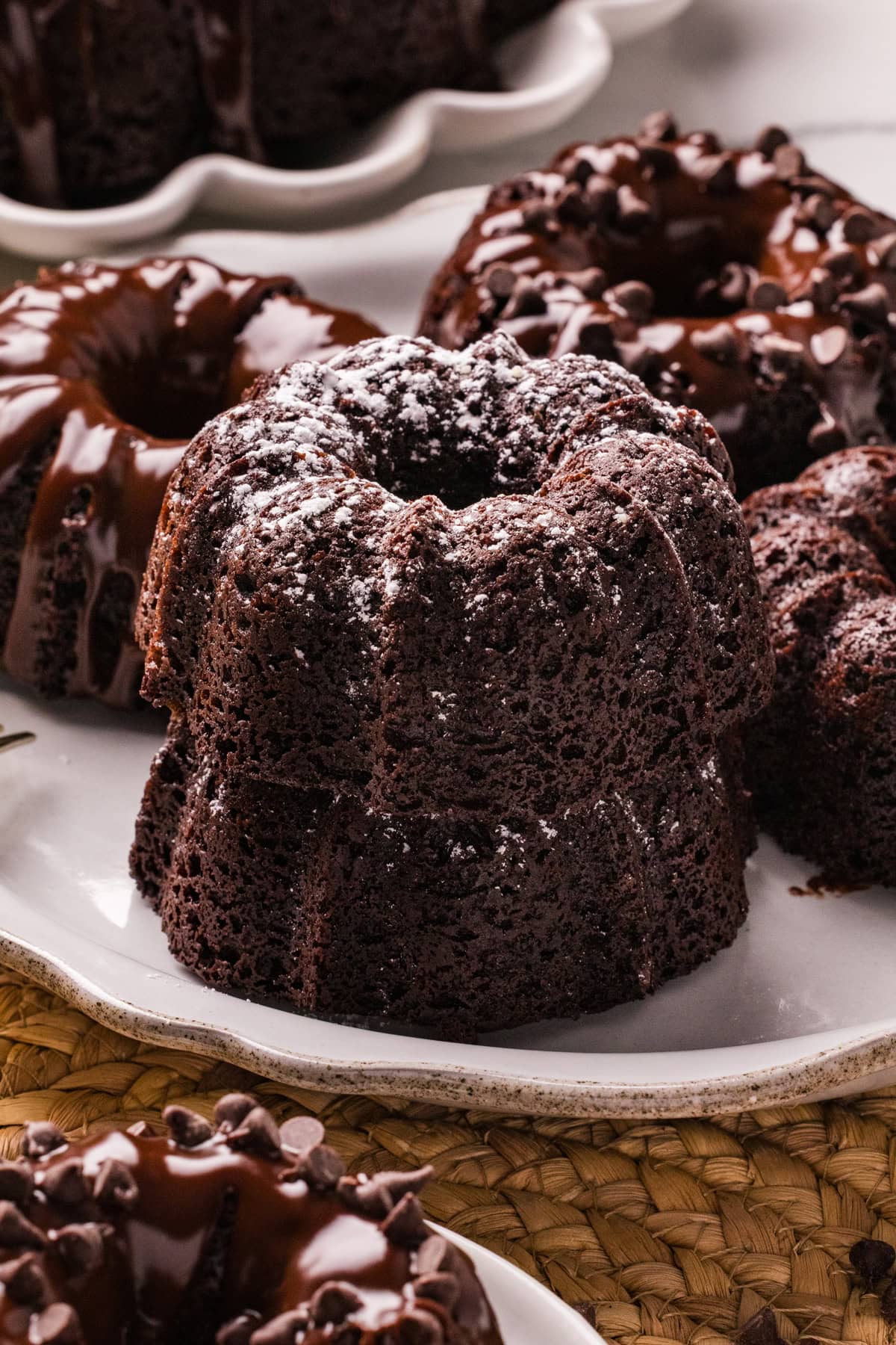 A plate of mini chocolate bundt cakes, two stacked in front