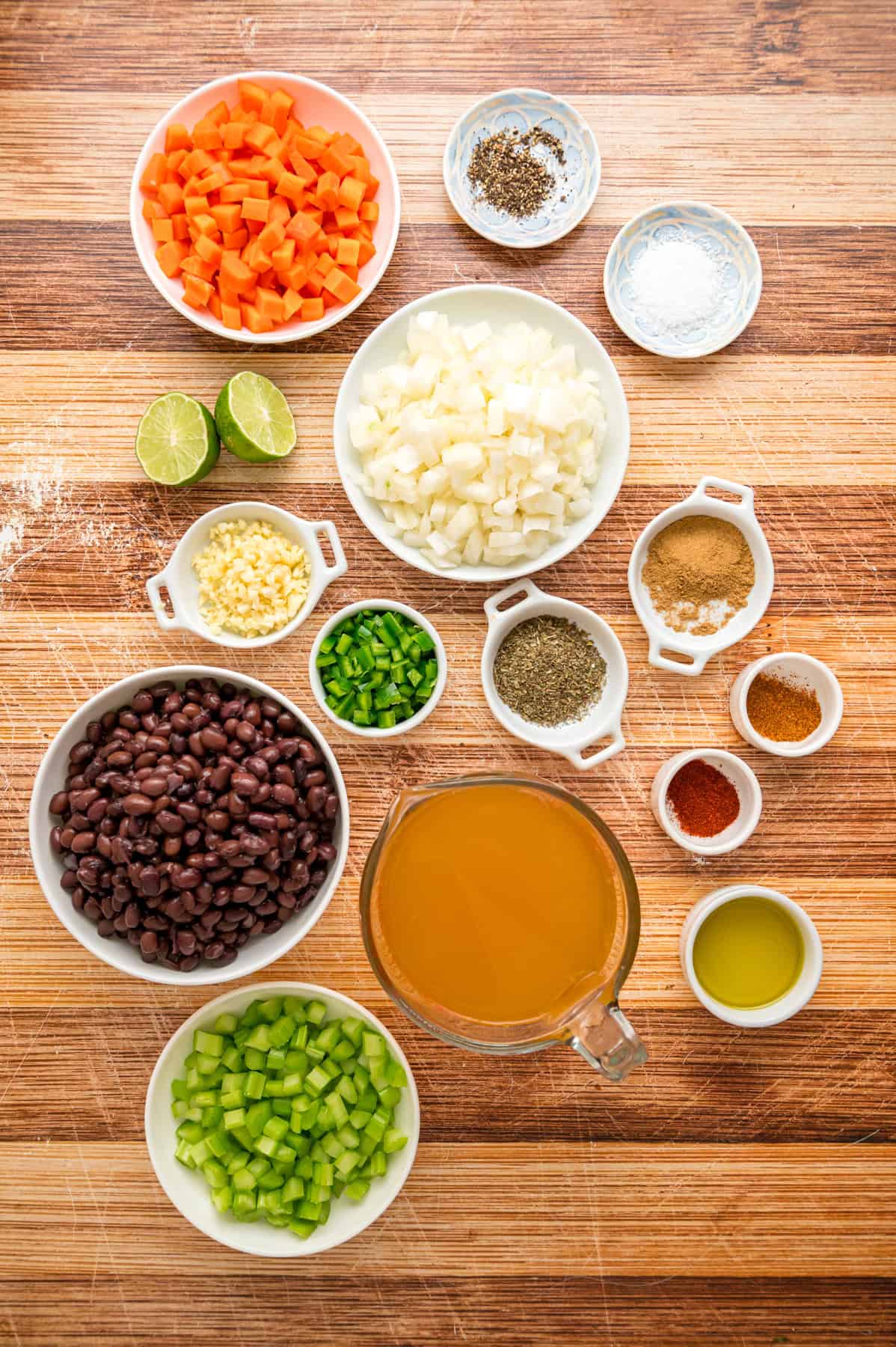 Black beans are simmered with warm, smoky spices and veggies in this Black Bean Soup recipe for an easy vegetarian dinner. Overhead view of ingredients needed to make black bean soup