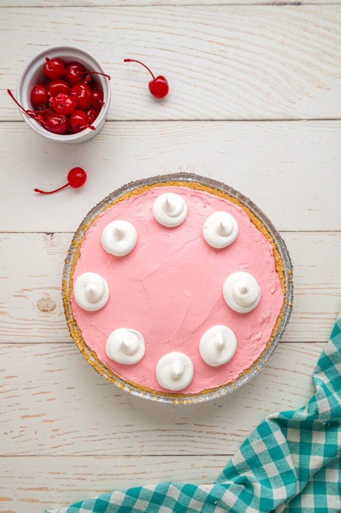 Made with cream cheese, sweetened condensed milk, and Kool Aid mix in a graham cracker crust, this No-Bake Kool Aid Pie is always a hit. Overhead view of Kool Aid pie