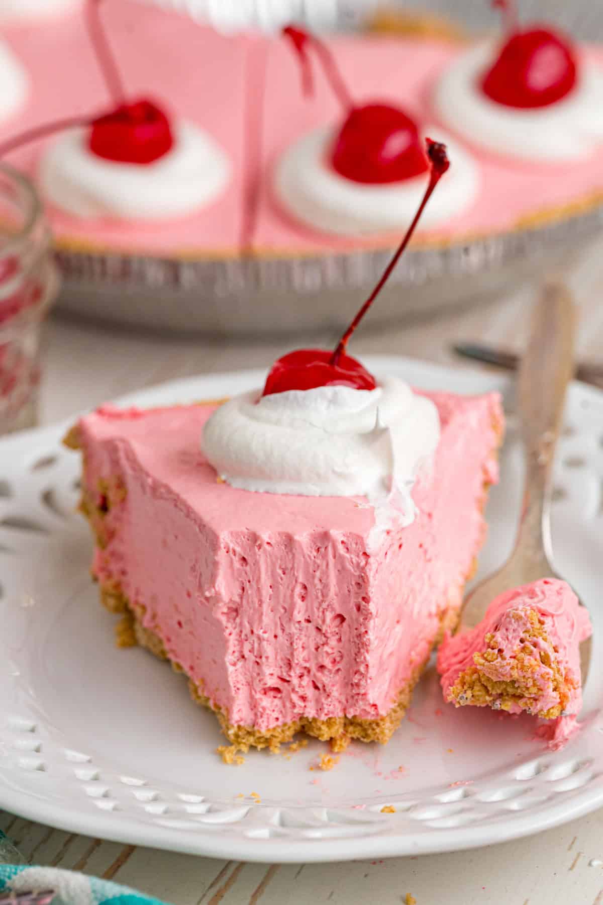 Made with cream cheese, sweetened condensed milk, and Kool Aid mix in a graham cracker crust, this No-Bake Kool Aid Pie is always a hit. No Bake Kool Aid Pie slice on a plate