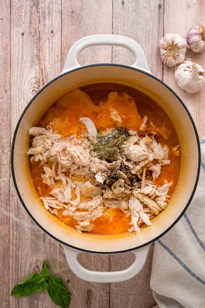 Shredded chicken, heavy cream, parmesan, and spices added to the pot