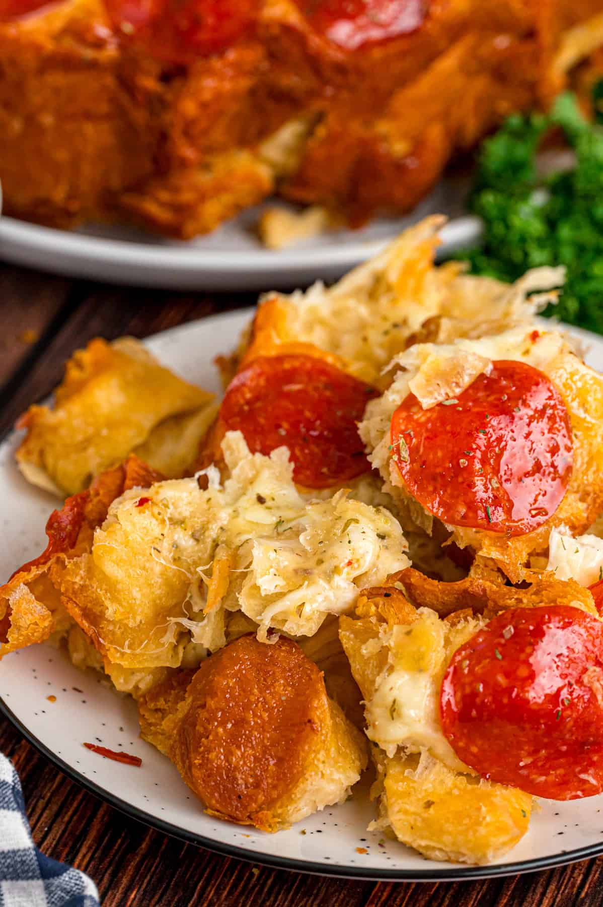 Made with biscuits, mozzarella cheese, and pepperoni, Pizza Pull Apart Bread is both easy to make and fun to eat. A plate of pizza pull apart bread