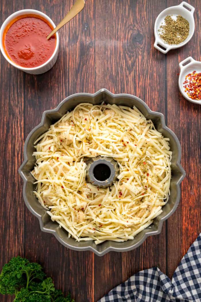 Made with biscuits, mozzarella cheese, and pepperoni, Pizza Pull Apart Bread is both easy to make and fun to eat. A layer of mozzarella cheese in a bundt pan