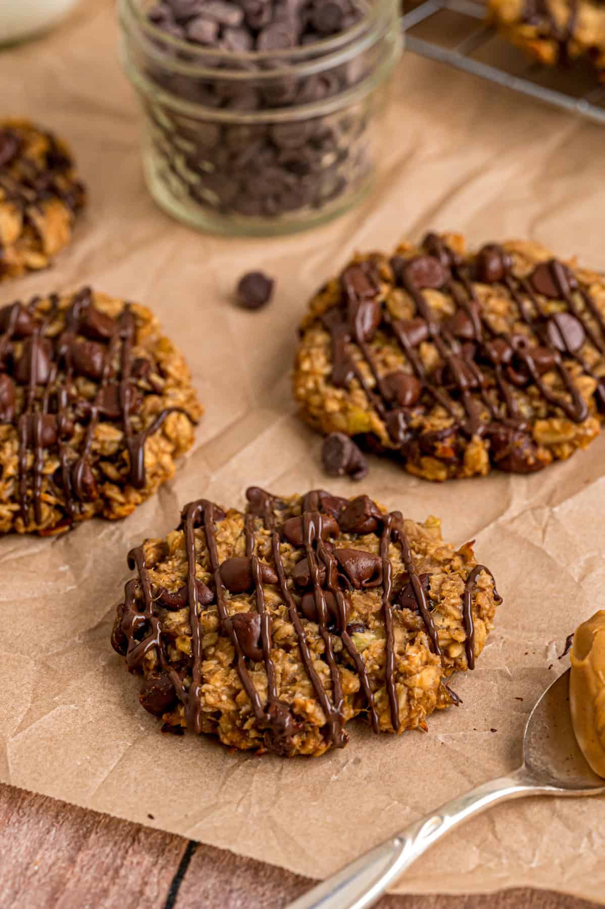 Made with just 3 ingredients in less than 25 minutes, these Banana Oatmeal Cookies are quick, easy, and so yummy. Three banana oatmeal cookies on parchment paper