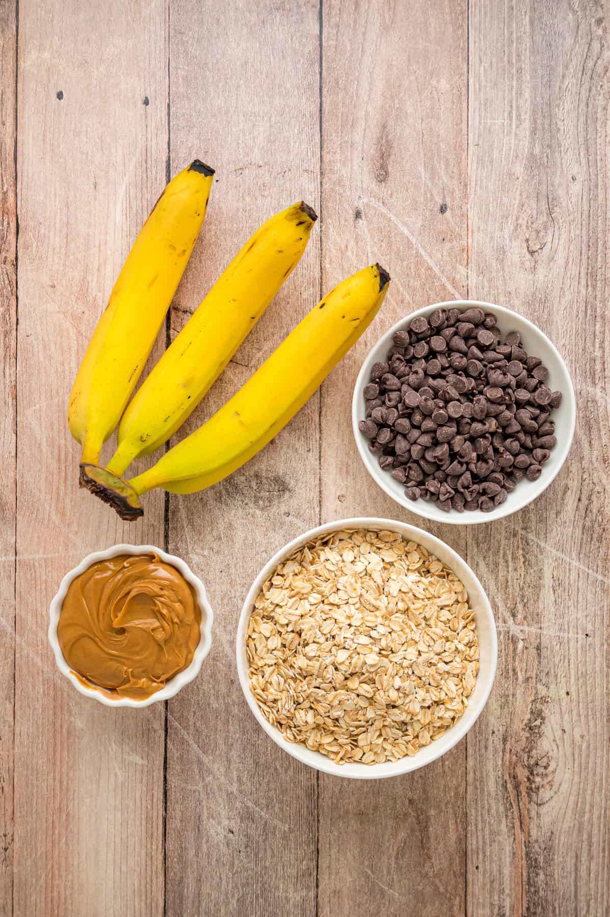Made with just 3 ingredients in less than 25 minutes, these Banana Oatmeal Cookies are quick, easy, and so yummy. Overhead view of ingredients needed to make banana oatmeal cookies