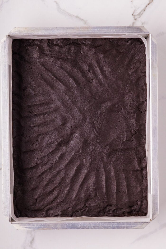 Chocolate Cheesecake Bars are ultra-decadent with three layers of chocolate. Easy to make & great for sharing! Chocolate shortbread crust pressed into a pan