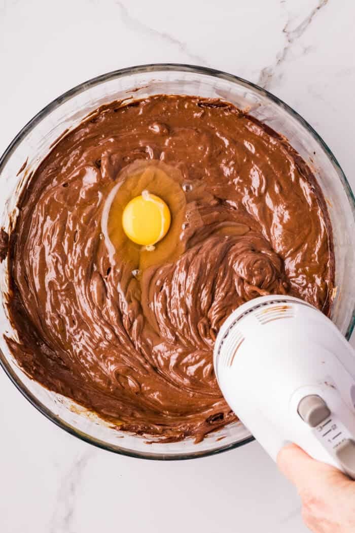 Chocolate Cheesecake Bars are ultra-decadent with three layers of chocolate. Easy to make & great for sharing! Eggs added to chocolate cheesecake filling