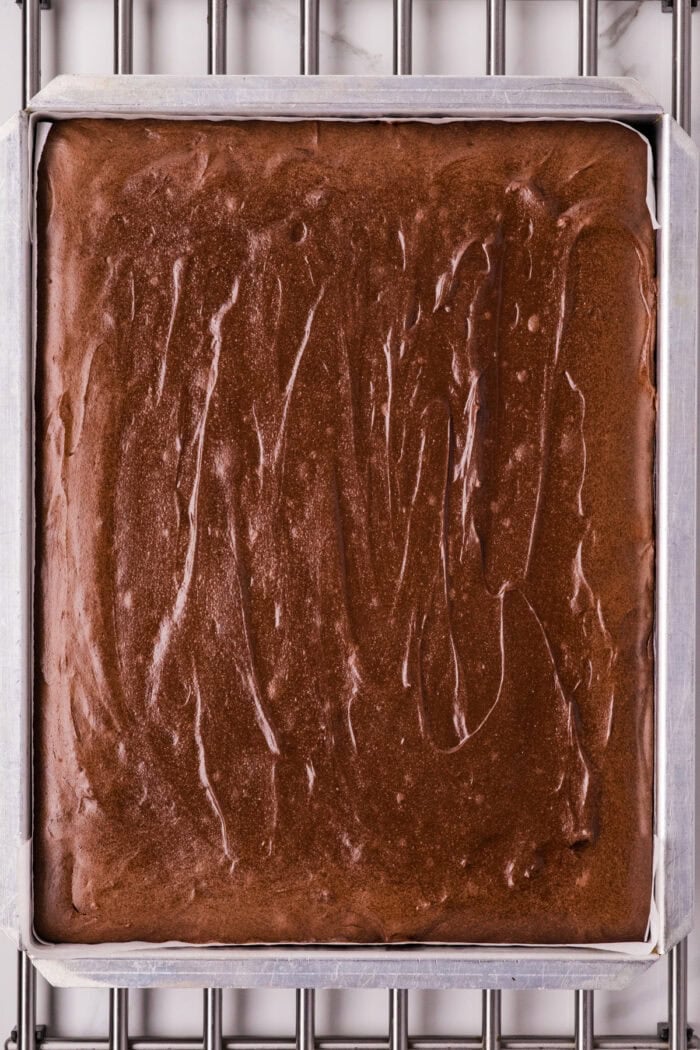 Chocolate Cheesecake Bars are ultra-decadent with three layers of chocolate. Easy to make & great for sharing! Baked chocolate cheesecake in a cake pan