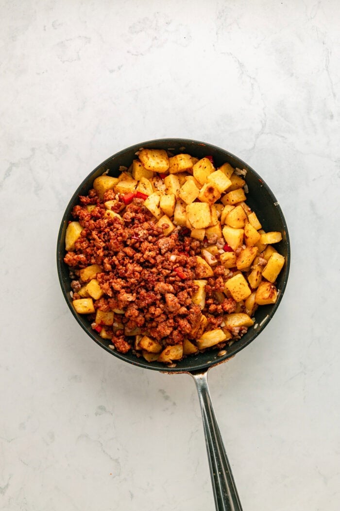 Chorizo added to the skillet of fried potatoes