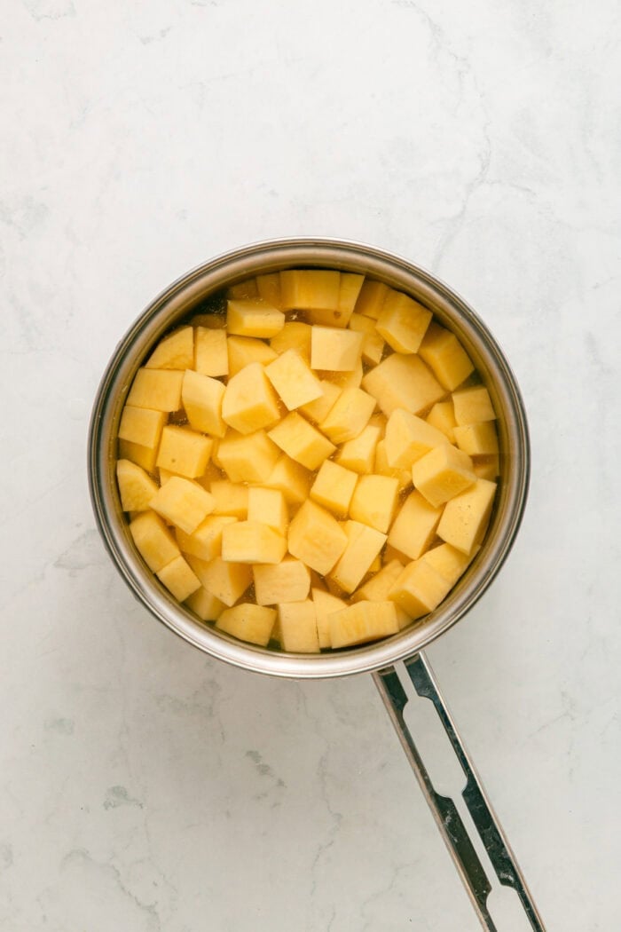 Cubed potatoes in a pot of water