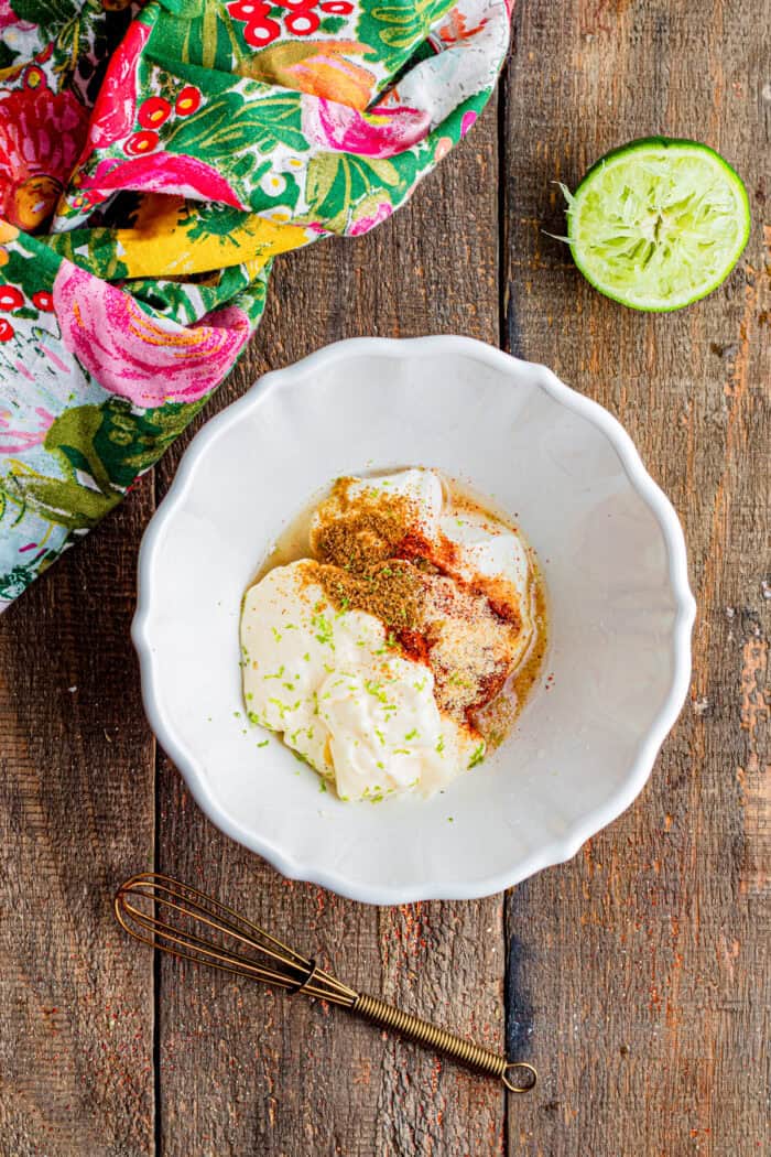 Mayo, sour cream, spices, and lime juice in a bowl
