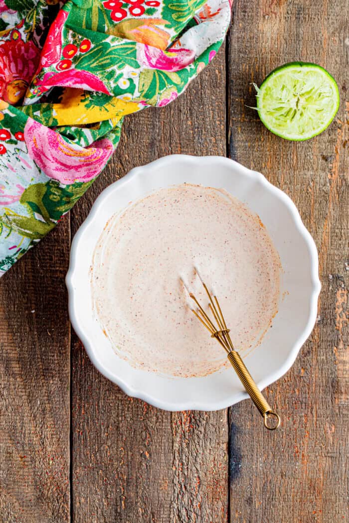 Whisking fish taco sauce ingredients together