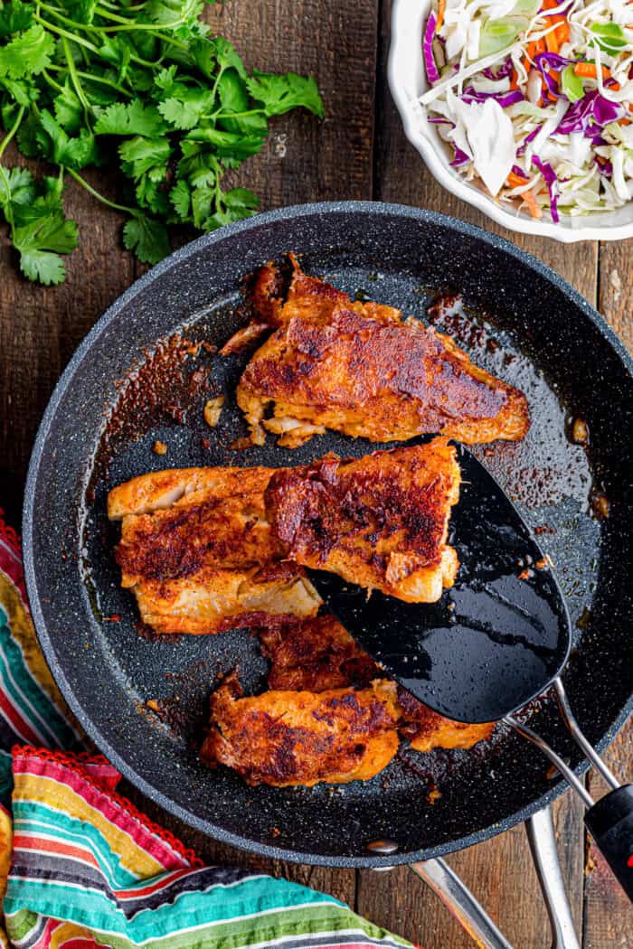 Topped with tangy fish taco sauce, these Blackened Fish Tacos are bold, flavorful, and ready in under 20 minutes. Blackened fish in a skillet