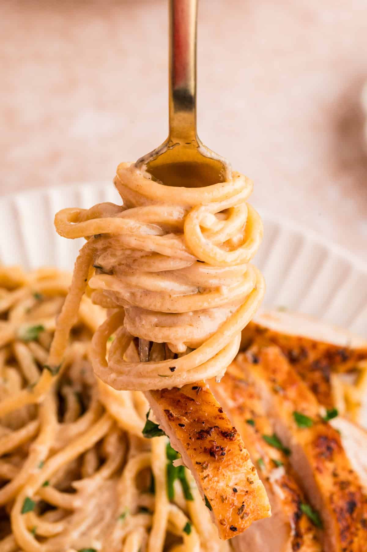 This Lemon Chicken Pasta is a quick, comforting dinner with bright citrus flavor and a rich, creamy sauce that feels restaurant-worthy. A fork twirling lemon chicken pasta