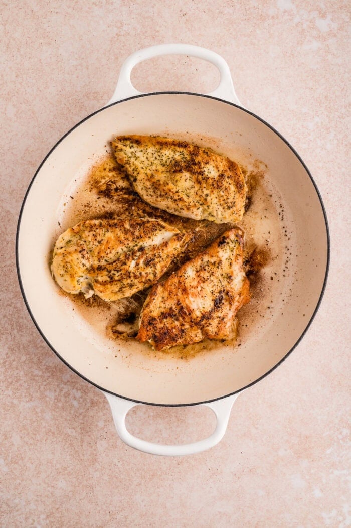 This Lemon Chicken Pasta is a quick, comforting dinner with bright citrus flavor and a rich, creamy sauce that feels restaurant-worthy. Chicken breasts cooking in a pan