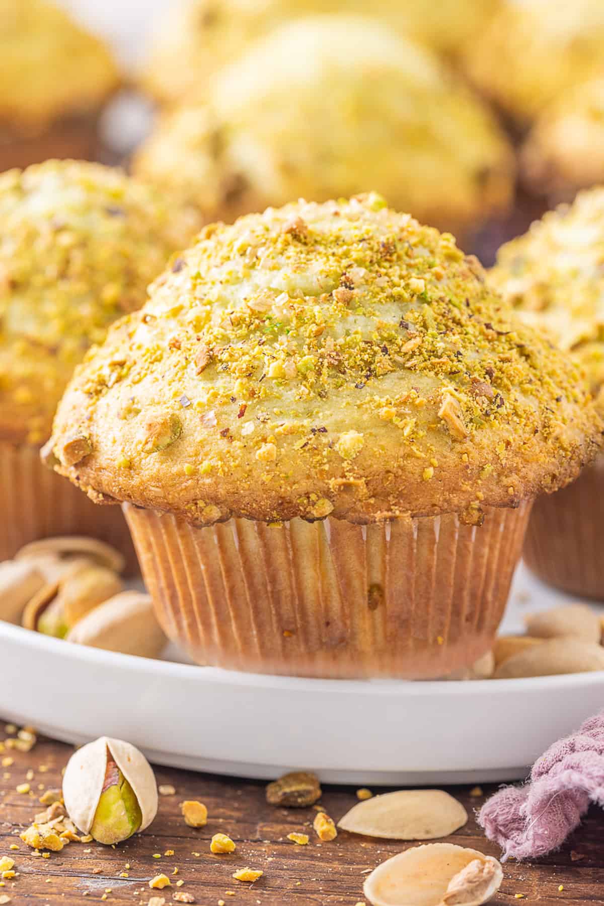 Front view of pistachio muffins on a white plate