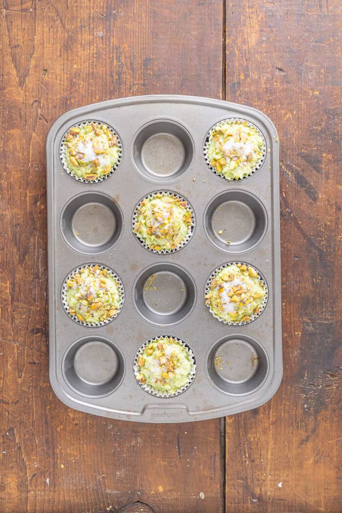 With tall bakery-style domes, these Pistachio Muffins are tender and moist with a lovely pistachio flavor. Quick & easy! Pistachio muffin batter in a muffin tin