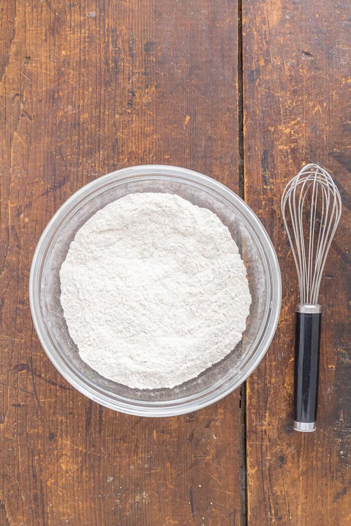 With tall bakery-style domes, these Pistachio Muffins are tender and moist with a lovely pistachio flavor. Quick & easy! Dry muffin ingredients in a bowl