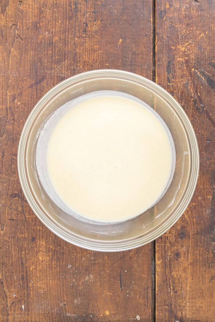 With tall bakery-style domes, these Pistachio Muffins are tender and moist with a lovely pistachio flavor. Quick & easy! Wet muffin ingredients in a bowl