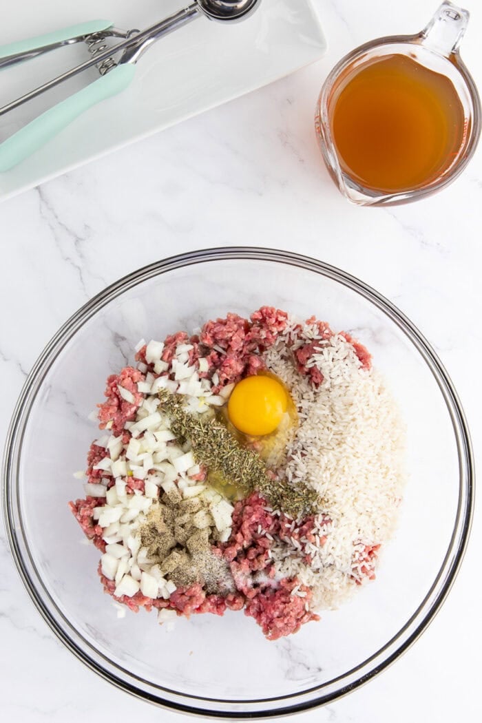 Ground beef, rice, seasonings, and egg in a bowl