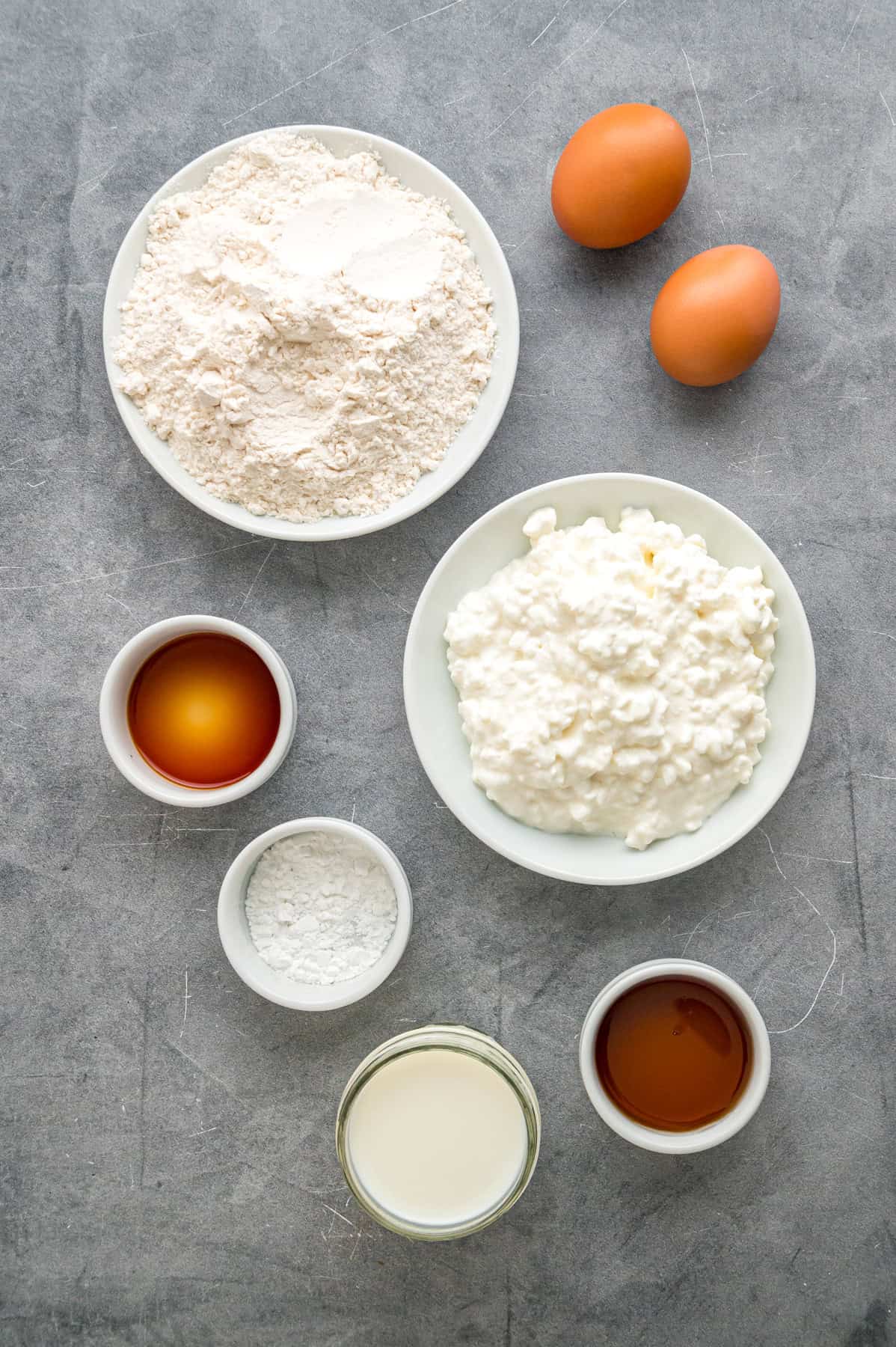 Made with just a handful of ingredients, these Cottage Cheese Pancakes are soft and filling with a lightly sweet flavor. Overhead view of ingredients needed to make cottage cheese pancakes