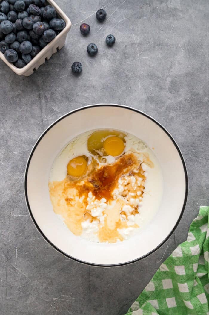 Made with just a handful of ingredients, these Cottage Cheese Pancakes are soft and filling with a lightly sweet flavor. Wet pancake ingredients in a bowl